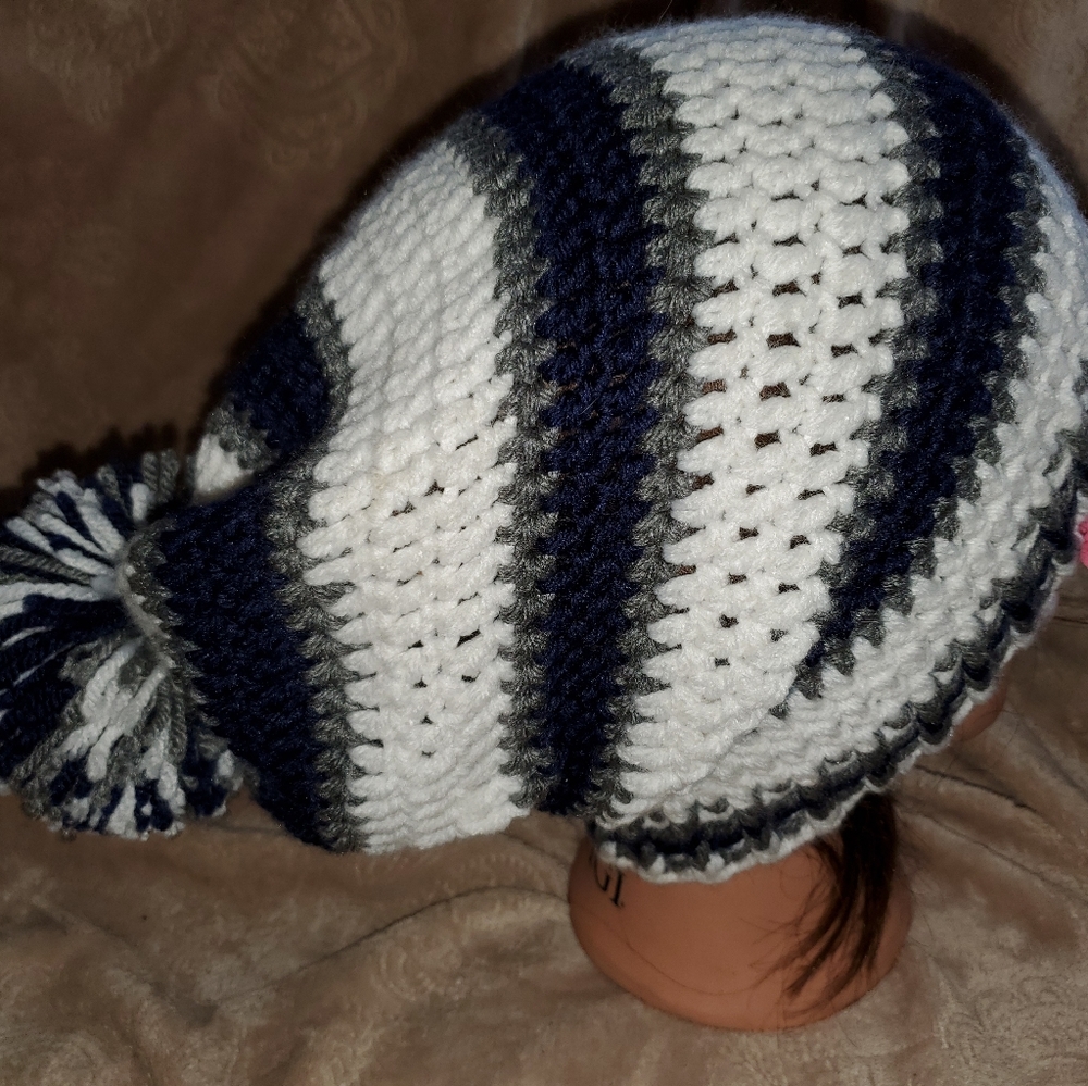 Crocheted slouchy pom pom beanie